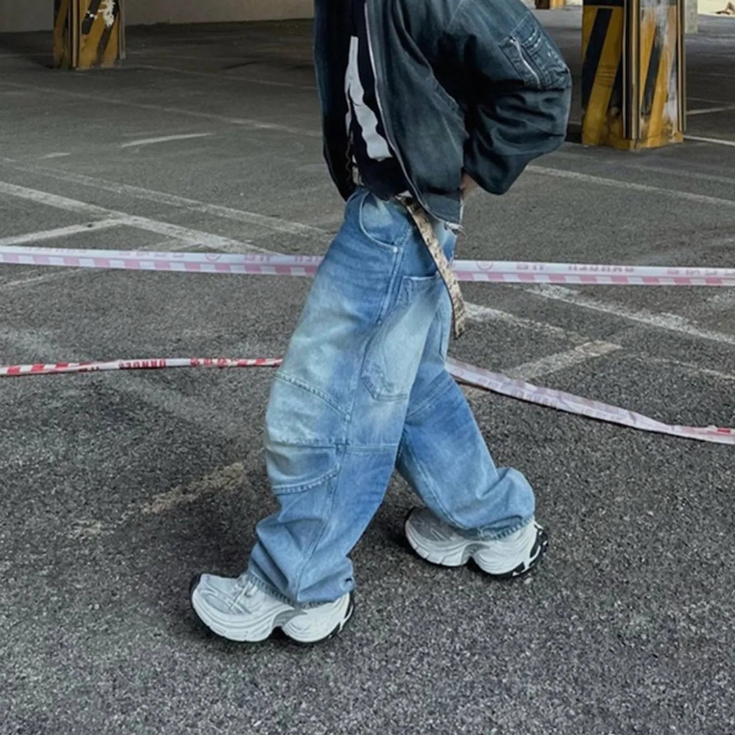 Men's washed light blue baggy jeans with a straight-leg cut and zip fly.