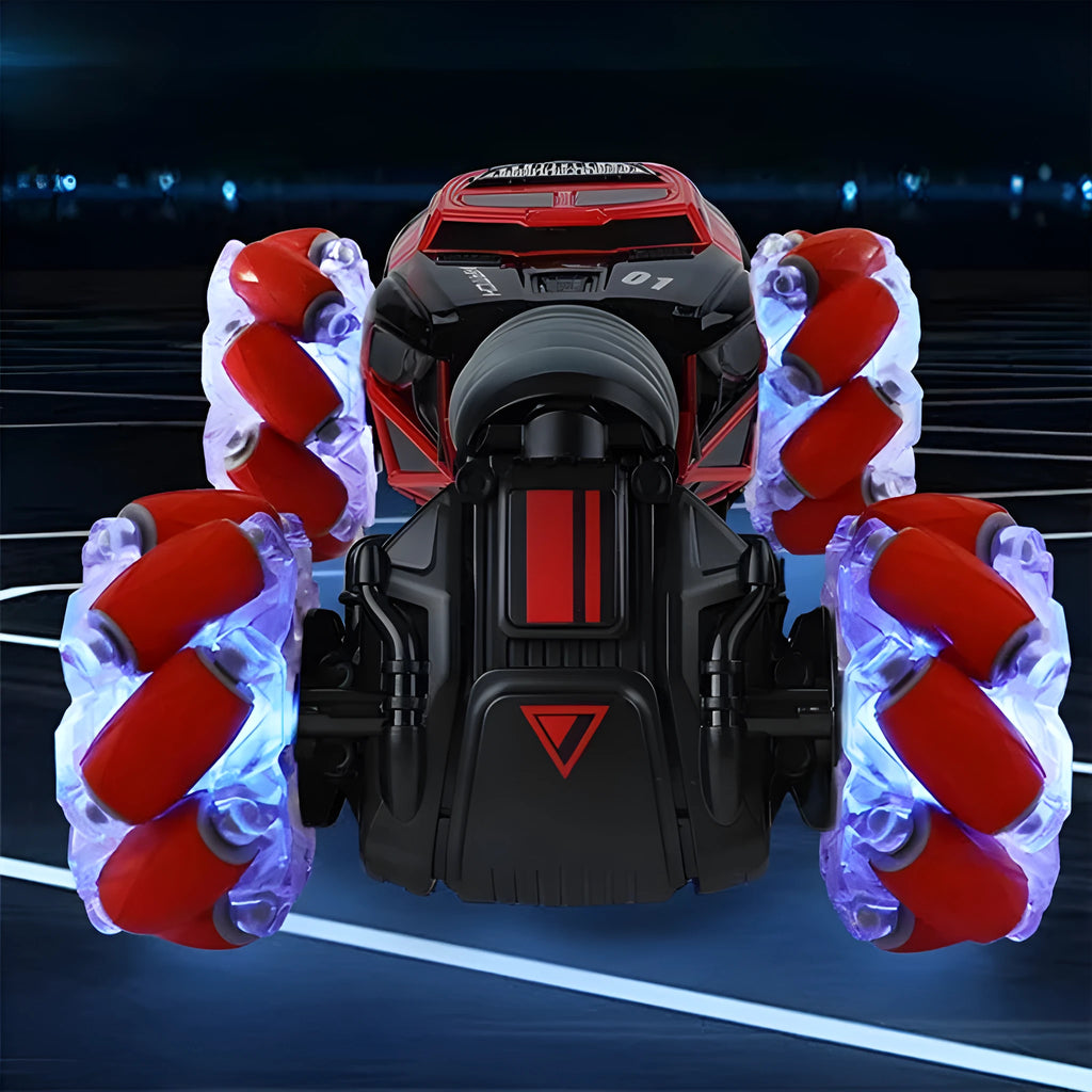Red remote control stunt car with gesture control, morphing off-road tyres, lights, and music, measuring 32 cm long