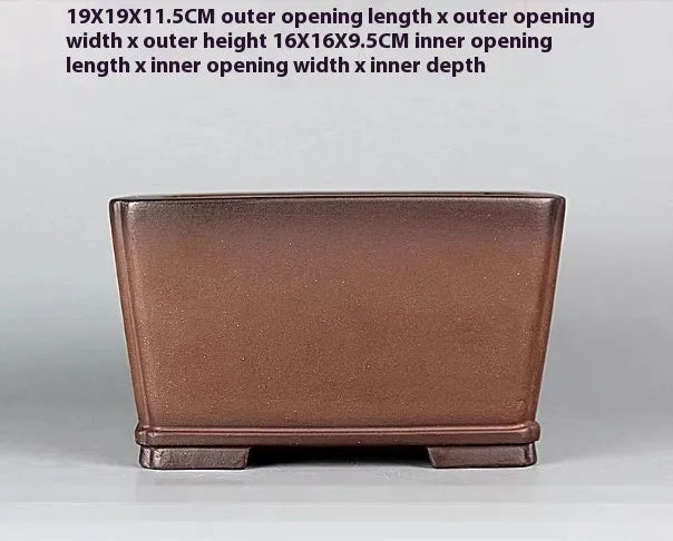 Handmade brown antique-style purple clay square flower pot on a surface.