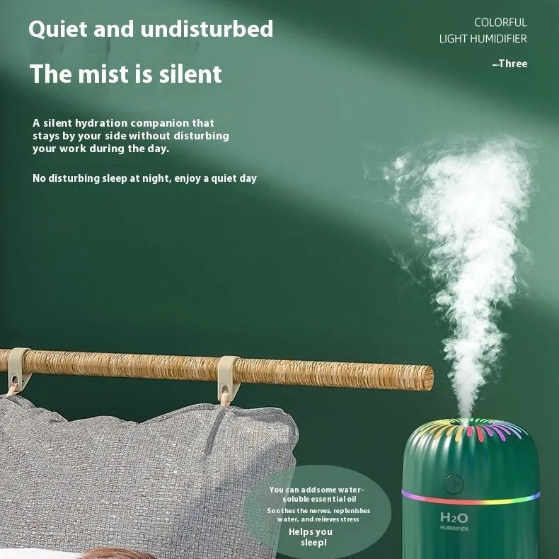 Mini green car-shaped USB aromatherapy humidifier on a desk