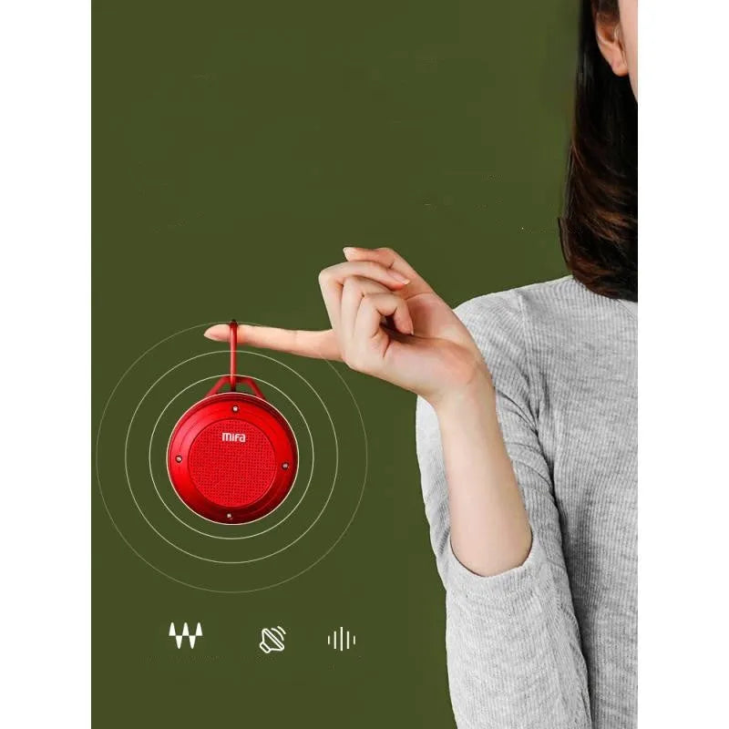 Portable Bluetooth speaker in grey silicone case with button controls, USB port, and compact size