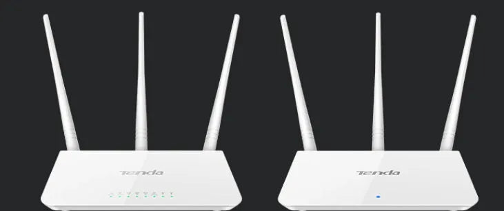White dual-band wireless broadband router with UK-style three-pin plug on a wooden desk.