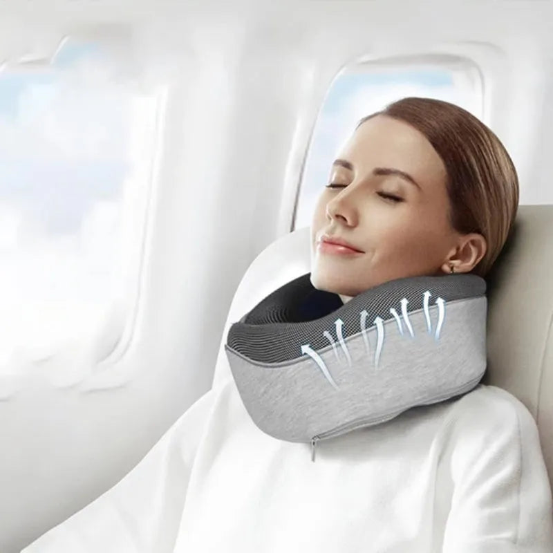 Navy blue memory foam U-shaped travel neck pillow rolled up next to its carry bag