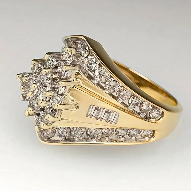 Geometric gold-coloured copper palace style ring on a plain background.