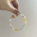 Orange alloy charm bracelet for women with a diamond-shaped charm and round bead details on a silver-tone chain.
