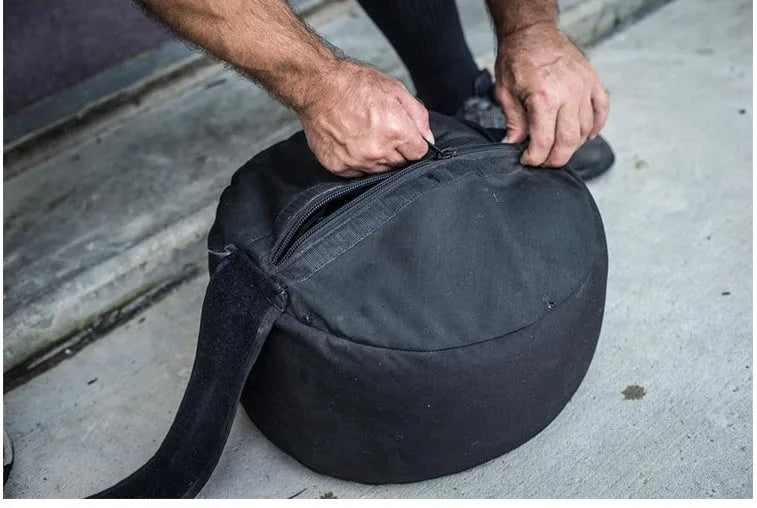 Black cylinder strongman sandbag with heavy duty 1000D nylon and YKK zipper for cross training