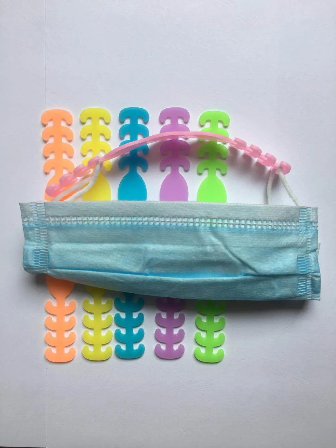 Eight silicone tool buckles in red, yellow, black, white, violet, pink, blue, and green colours.