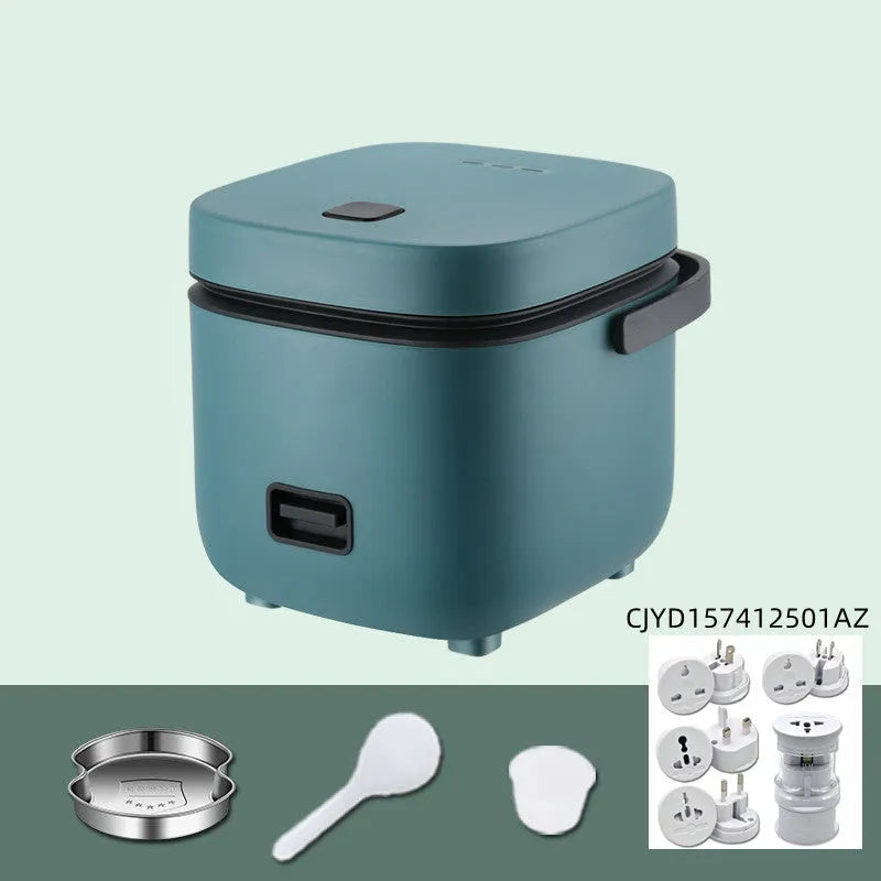 Green mini rice cooker 1.2L with steaming plate, rice spoon and measuring cup on countertop