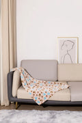 Blue cartoon dog paw print pattern on a thick double-sided flannel pet blanket laid flat.