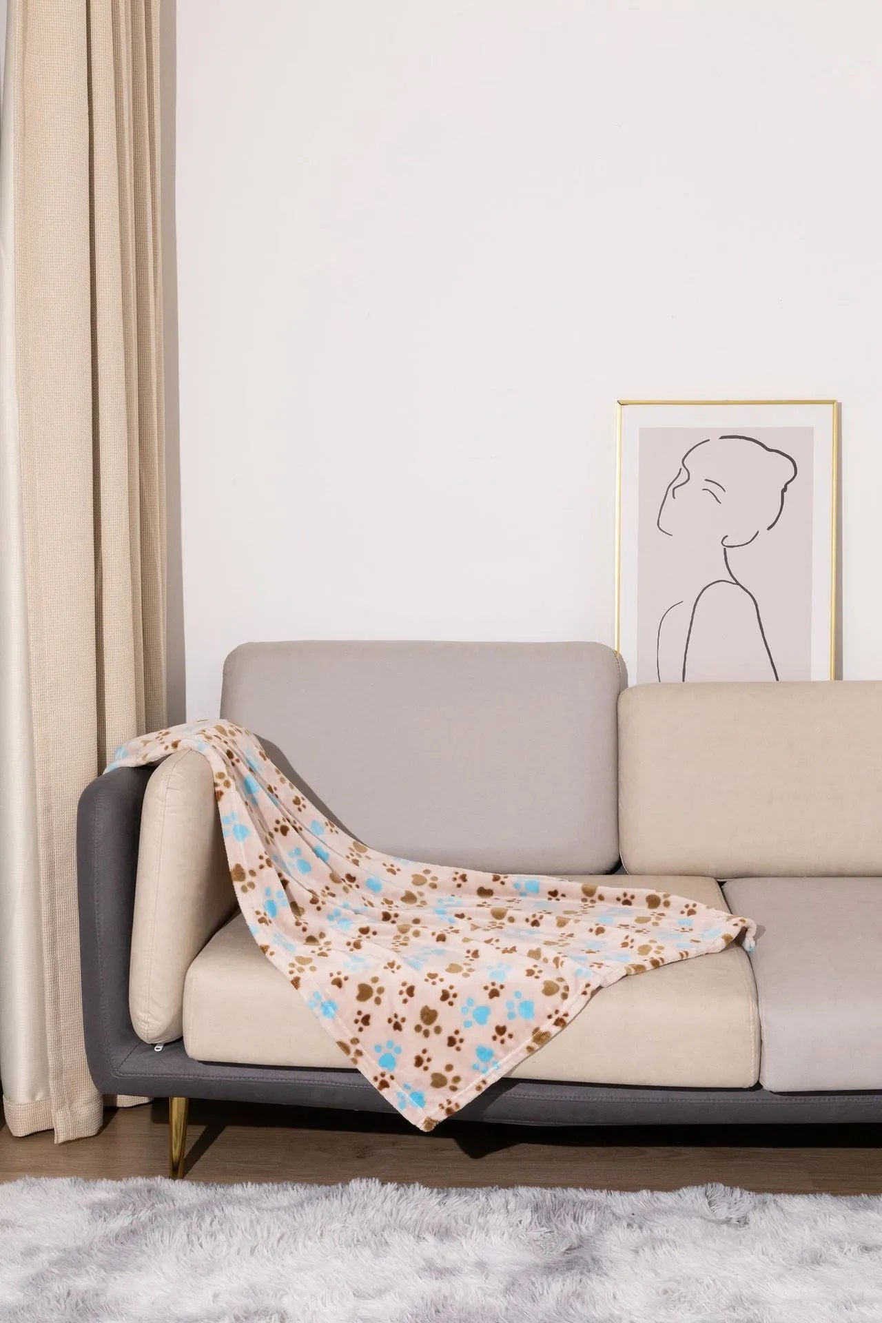 Blue cartoon dog paw print pattern on a thick double-sided flannel pet blanket laid flat.