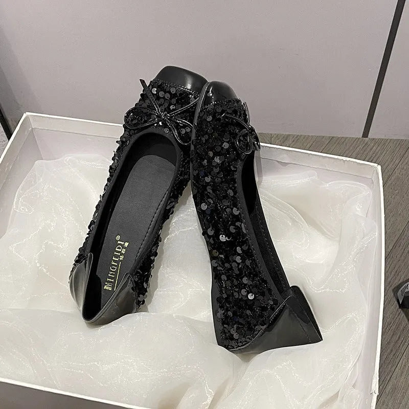 Women's black satin Mary Jane pump with height increasing insole, rhinestones, buckle, and square toe