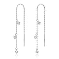 Gold pair of copper geometric round earrings with small zircon stone and ear hook closure on neutral background
