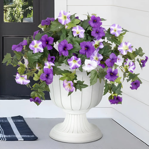 Purple plastic garden container with 12 forks holding red artificial silk flowers on a patio.