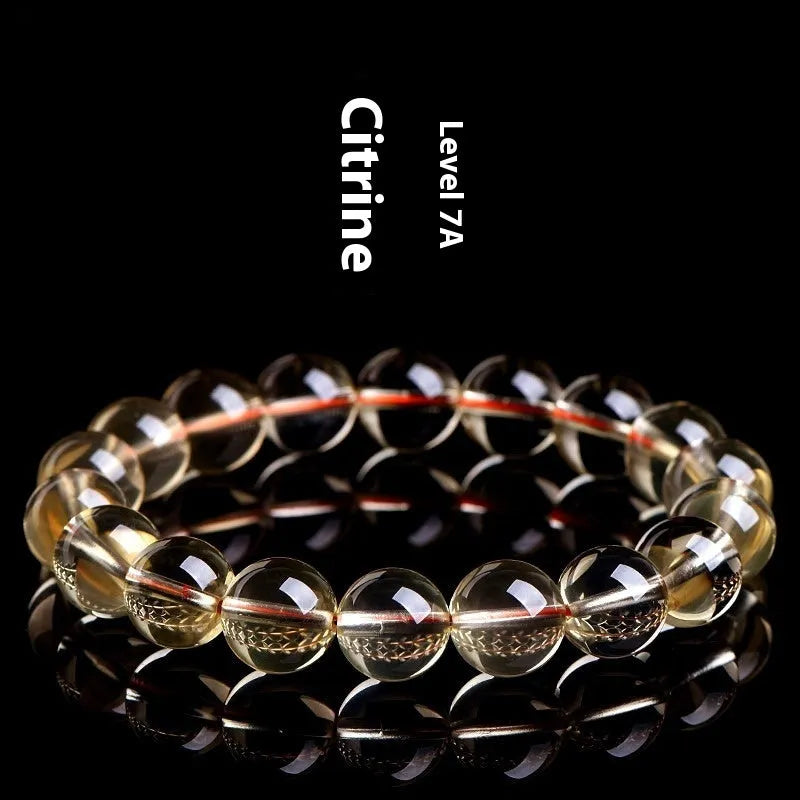 Original design bracelet with scattered, polished natural citrine beads in golden yellow tones on a wrist.