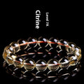 Original design bracelet with scattered, polished natural citrine beads in golden yellow tones on a wrist.