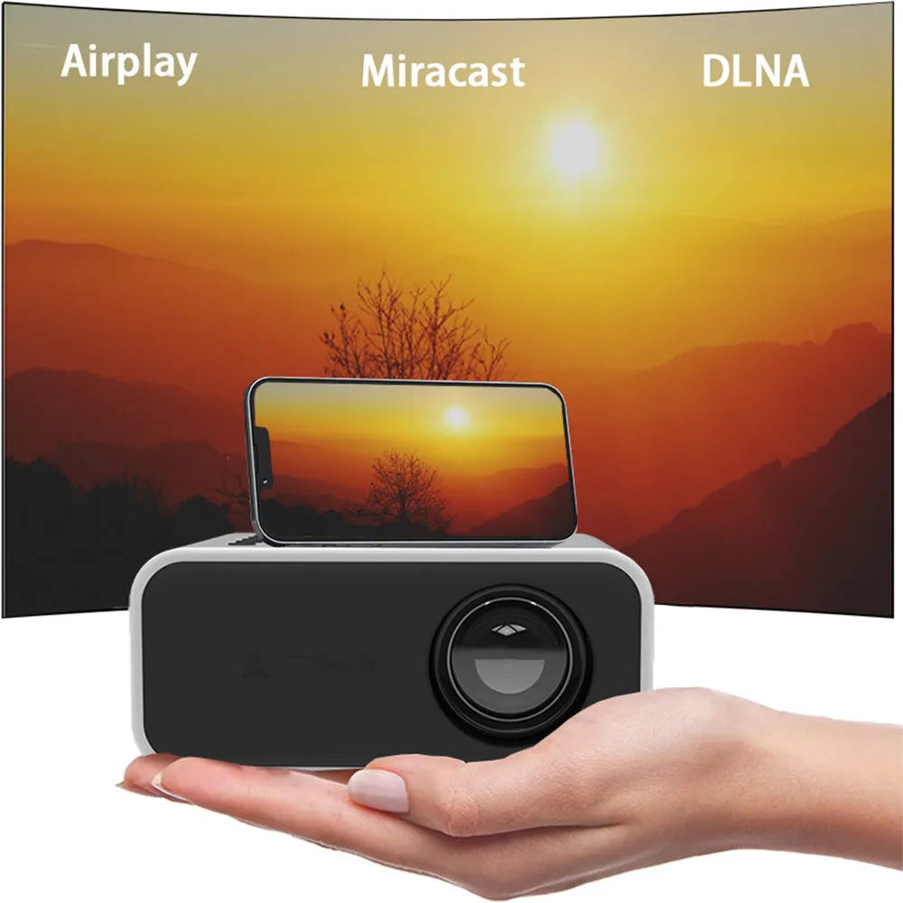 YT300 black portable mini projector with remote control on table showing projection