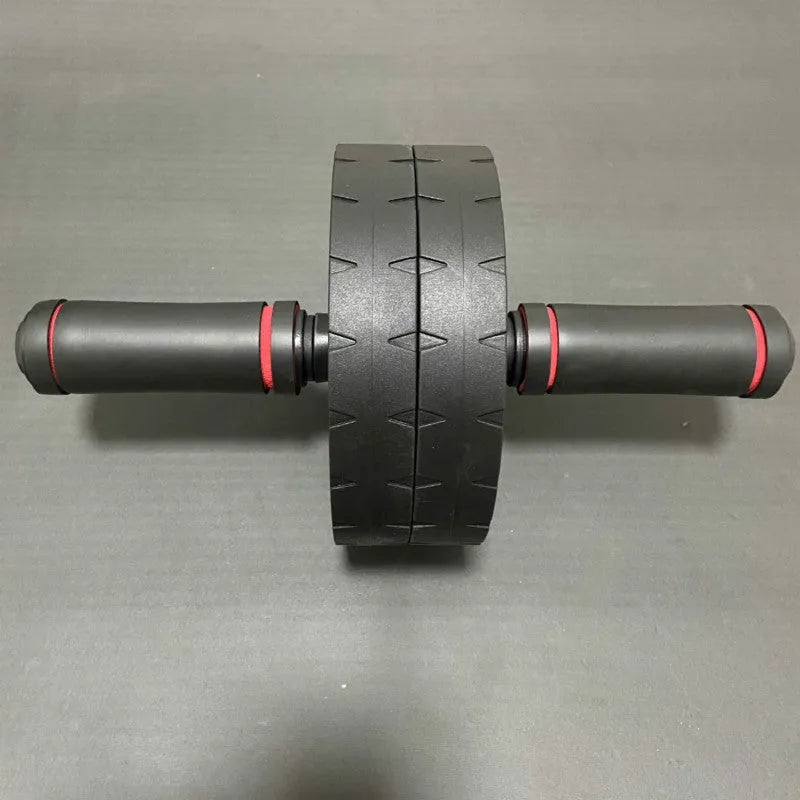 Black rebound abdominal roller with rubber wheel on a white background