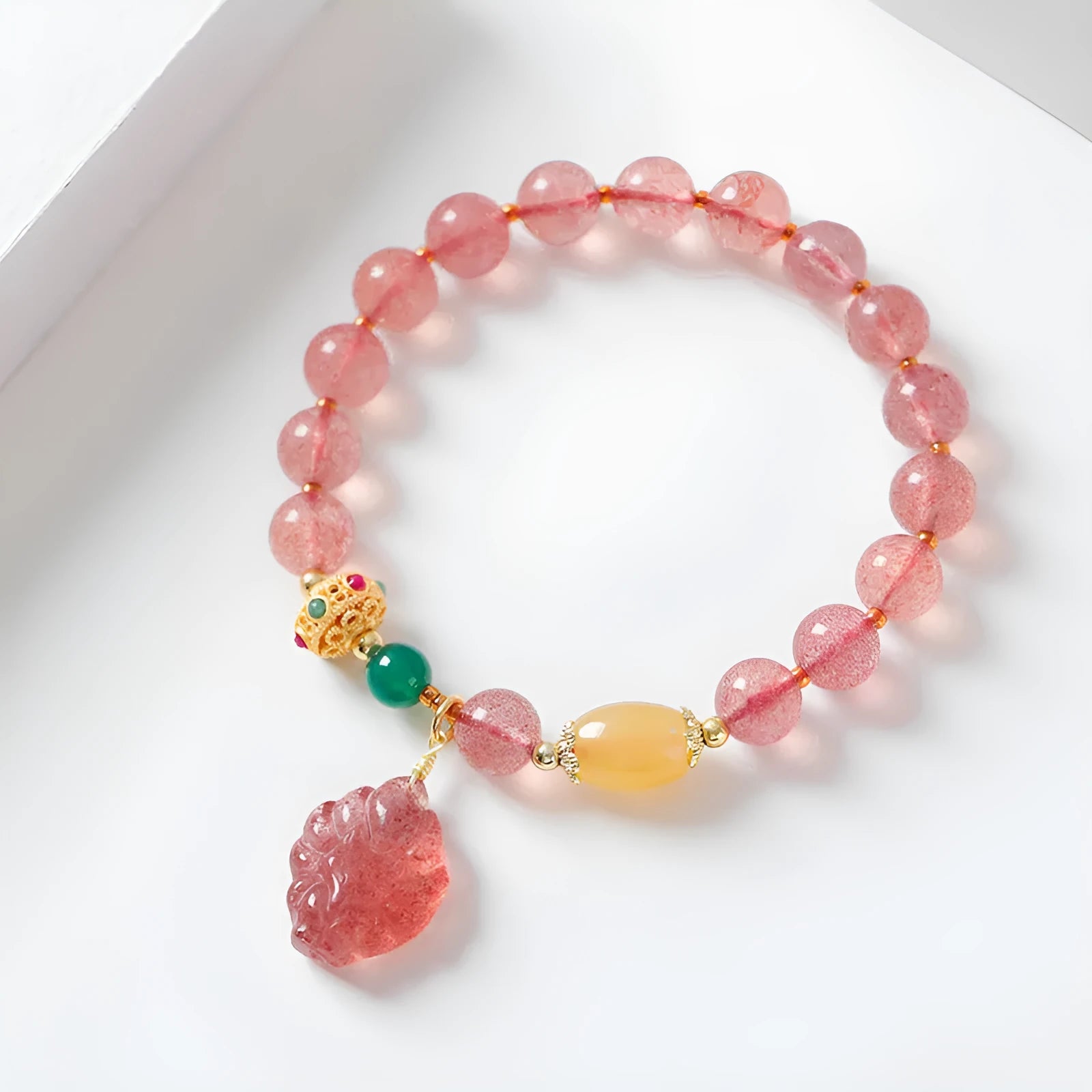 Close-up of a women's crystal beaded bracelet with a nine tail fox charm on a model's wrist.