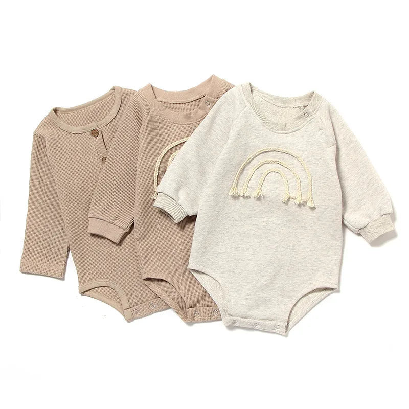 Beige waffle cotton baby romper with long sleeves and cotton rope tie fastening.