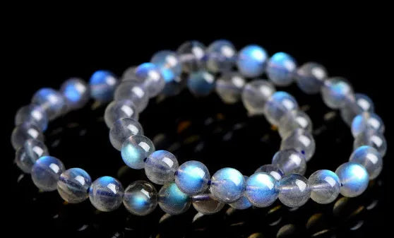 Blue Moonlight quartz bracelet with natural cream body beads on a white background.