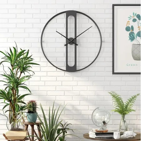 Round metal wall clock with 50cm diameter in black or gold finish on white wall