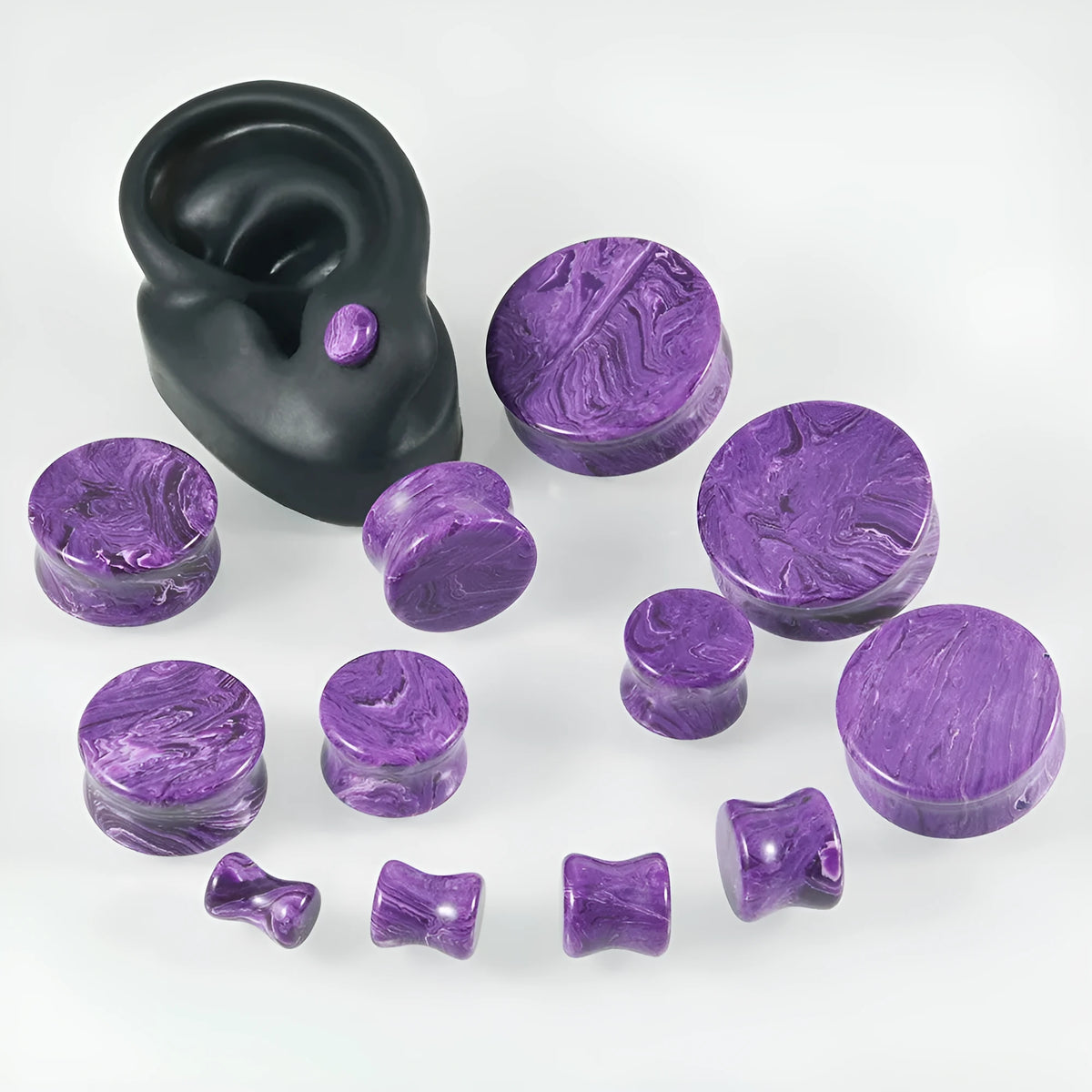 Crystal red flower stone solid expansion earplug on grey background, 6mm to 30mm sizes available, unisex geometric design