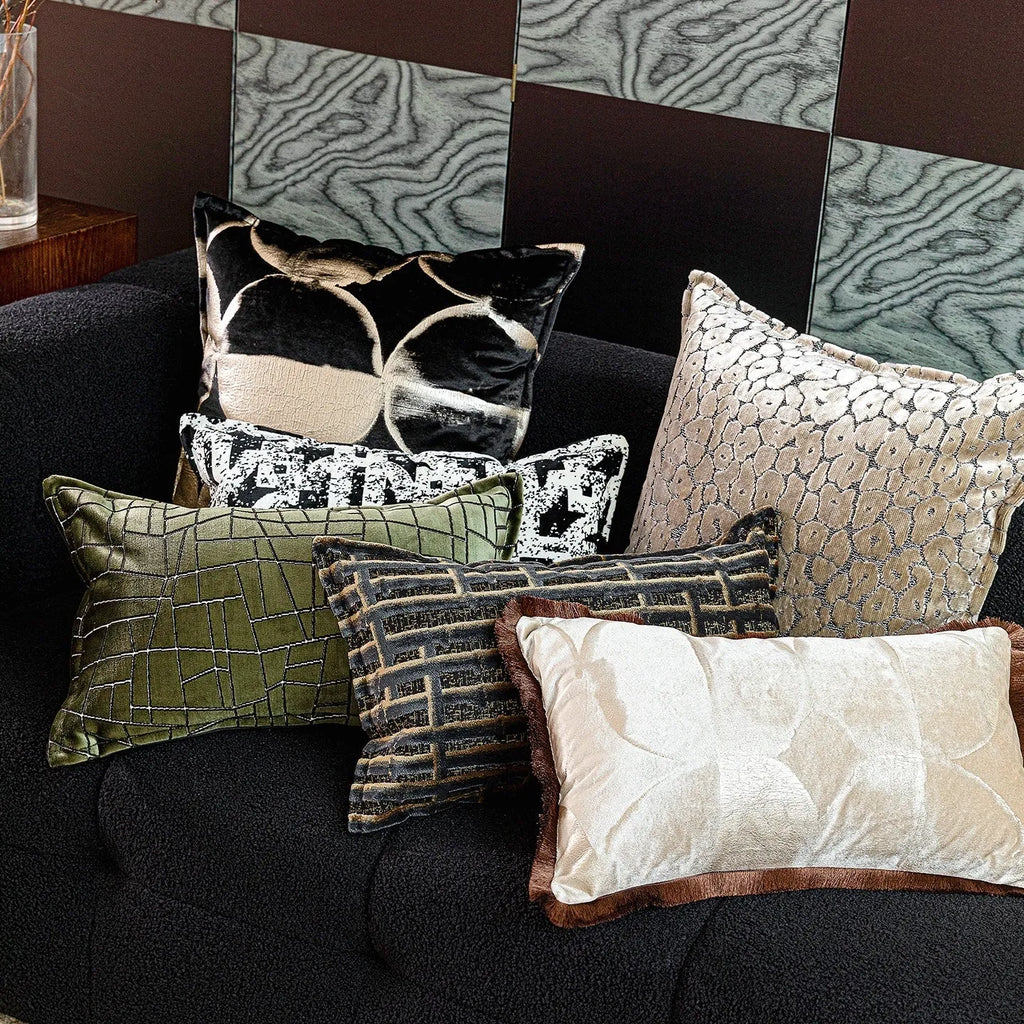 Black and gold abstract full moon pattern flannel cushion on a grey sofa