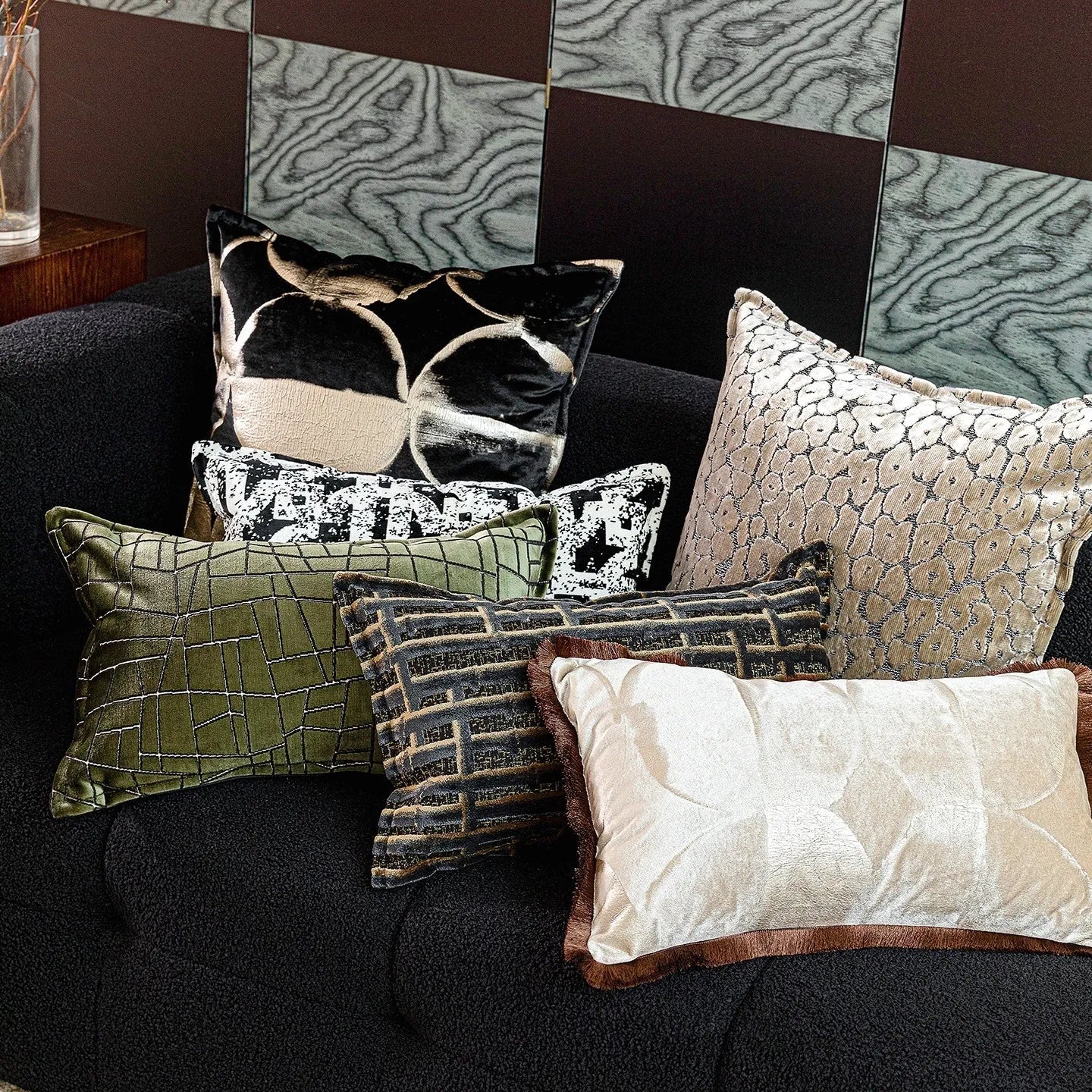 Black and gold abstract full moon pattern flannel cushion on a grey sofa