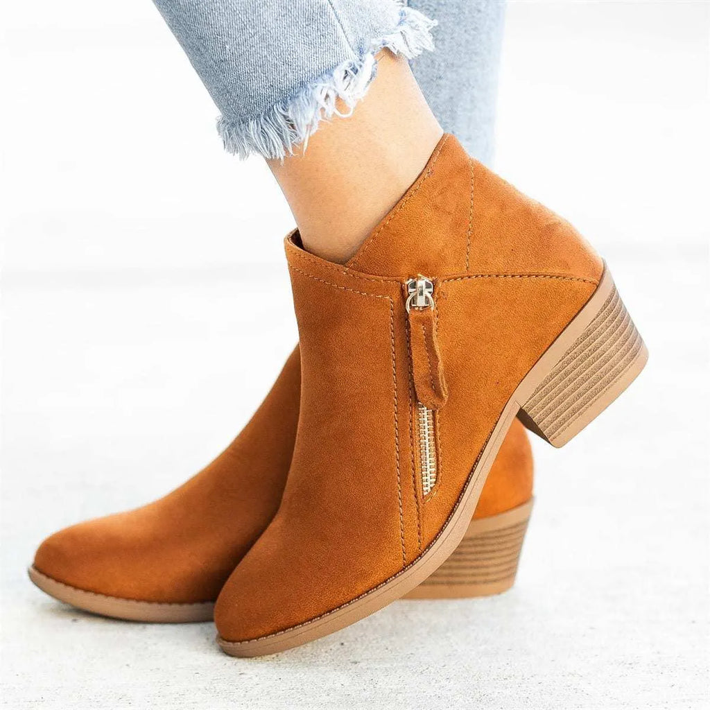 Women's blue suede ankle boots with side zip and chunky heel on white background