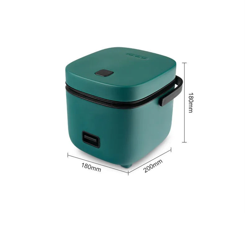 Green mini rice cooker 1.2L with steaming plate, rice spoon and measuring cup on countertop