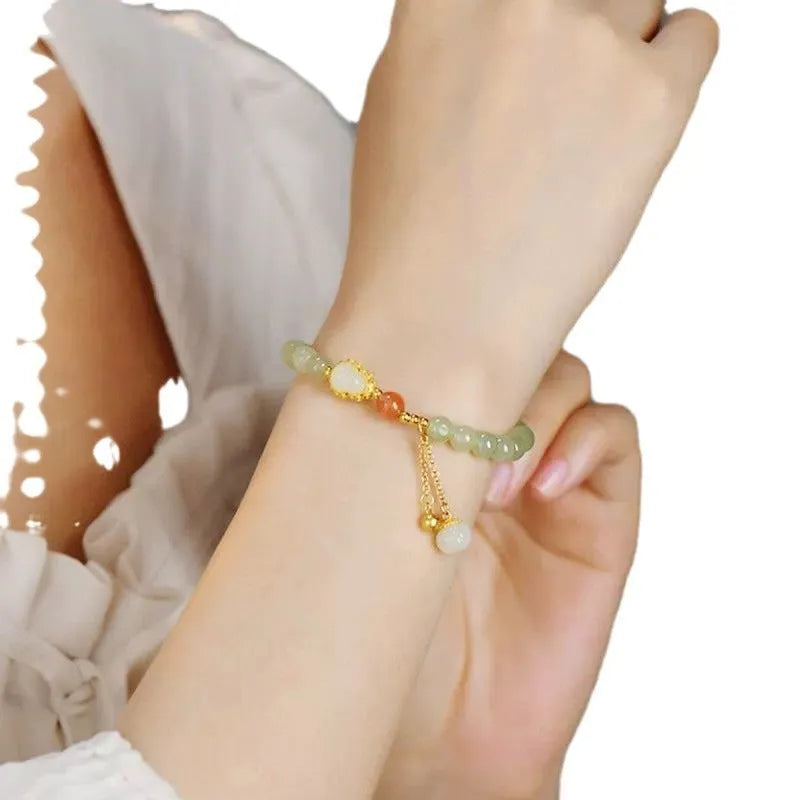 Jade and gold plated women's bracelet with fu character charm and Chinese knot fastening