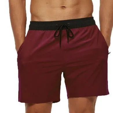 Men's blue drawstring athletic shorts with a zip pocket and stitching detail on the waistband.