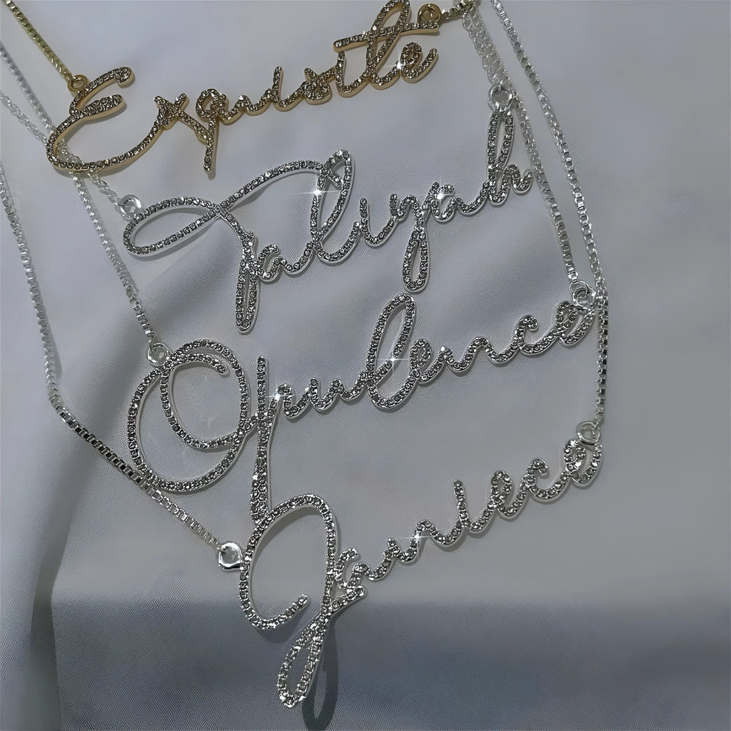 Stainless steel personalised name necklace with diamond-studded letters on an adjustable chain in silver, gold, or rose gold.