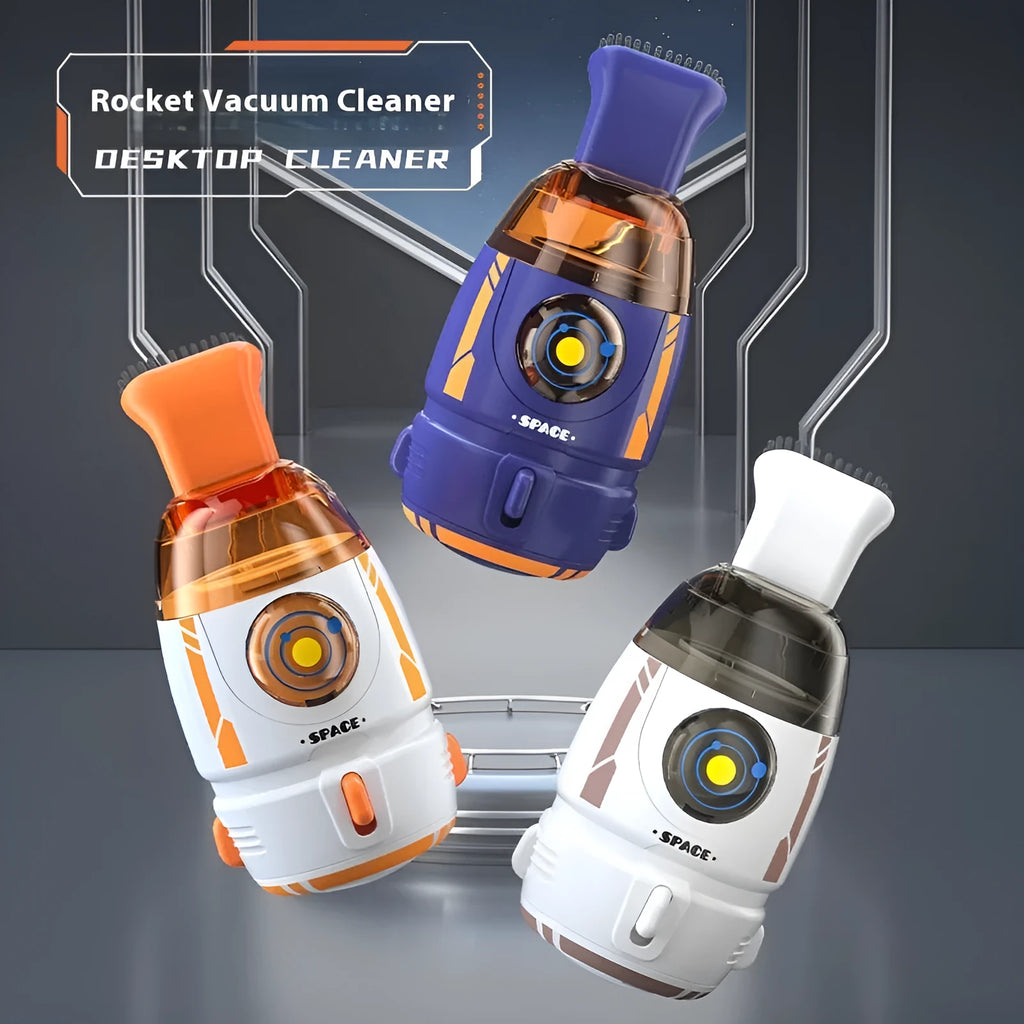 USB-powered handheld desktop vacuum cleaner in blue rocket design on a wooden desk next to a keyboard.