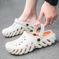 Men's beige EVA slipper sandals with hollow-out design and non-slip sole, shown from a side angle.