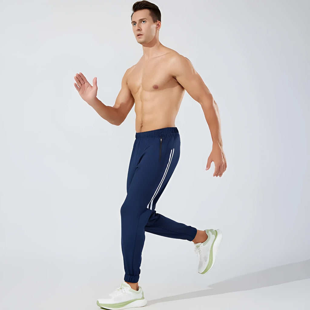 Man wearing black full-length polyester running trousers with a mid waist design.