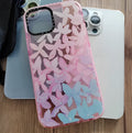 Transparent TPU phone case with pink and blue petal pattern for iPhone showing fall prevention feature