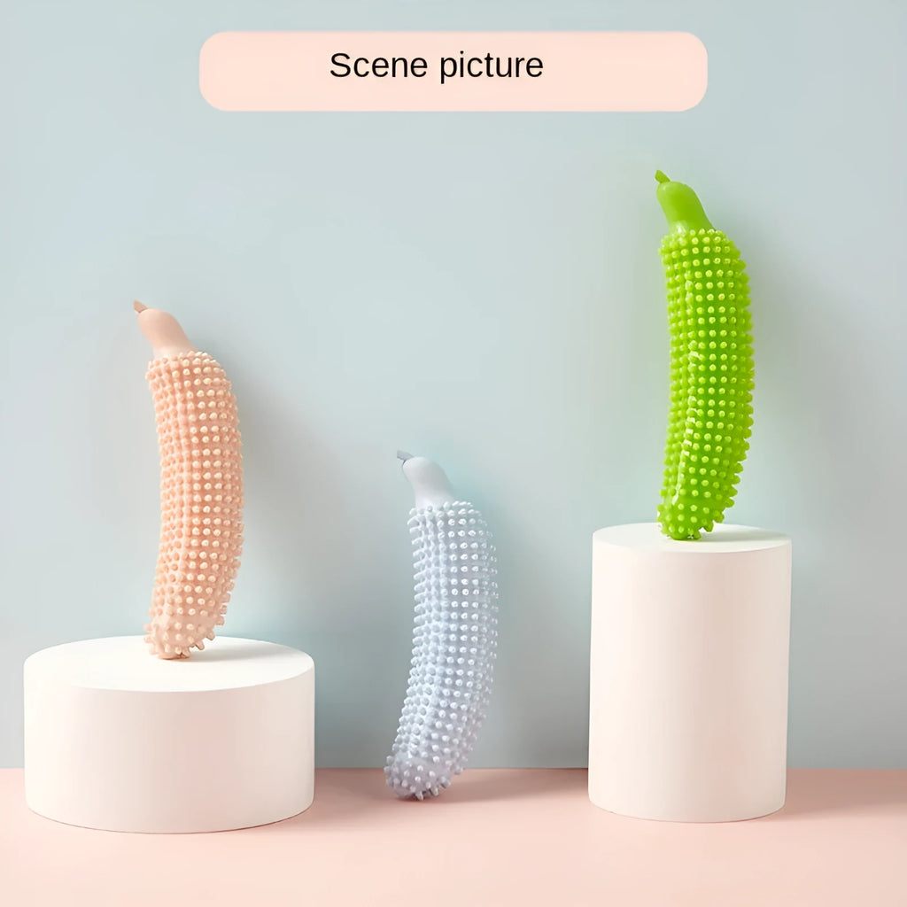 Green cucumber-shaped dog chew toy with a squeaker on a white background