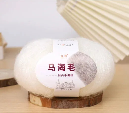 Hand-woven DIY mohair scarf kit with wool ball, shown in a selection of colours including beige, pink, and blue.