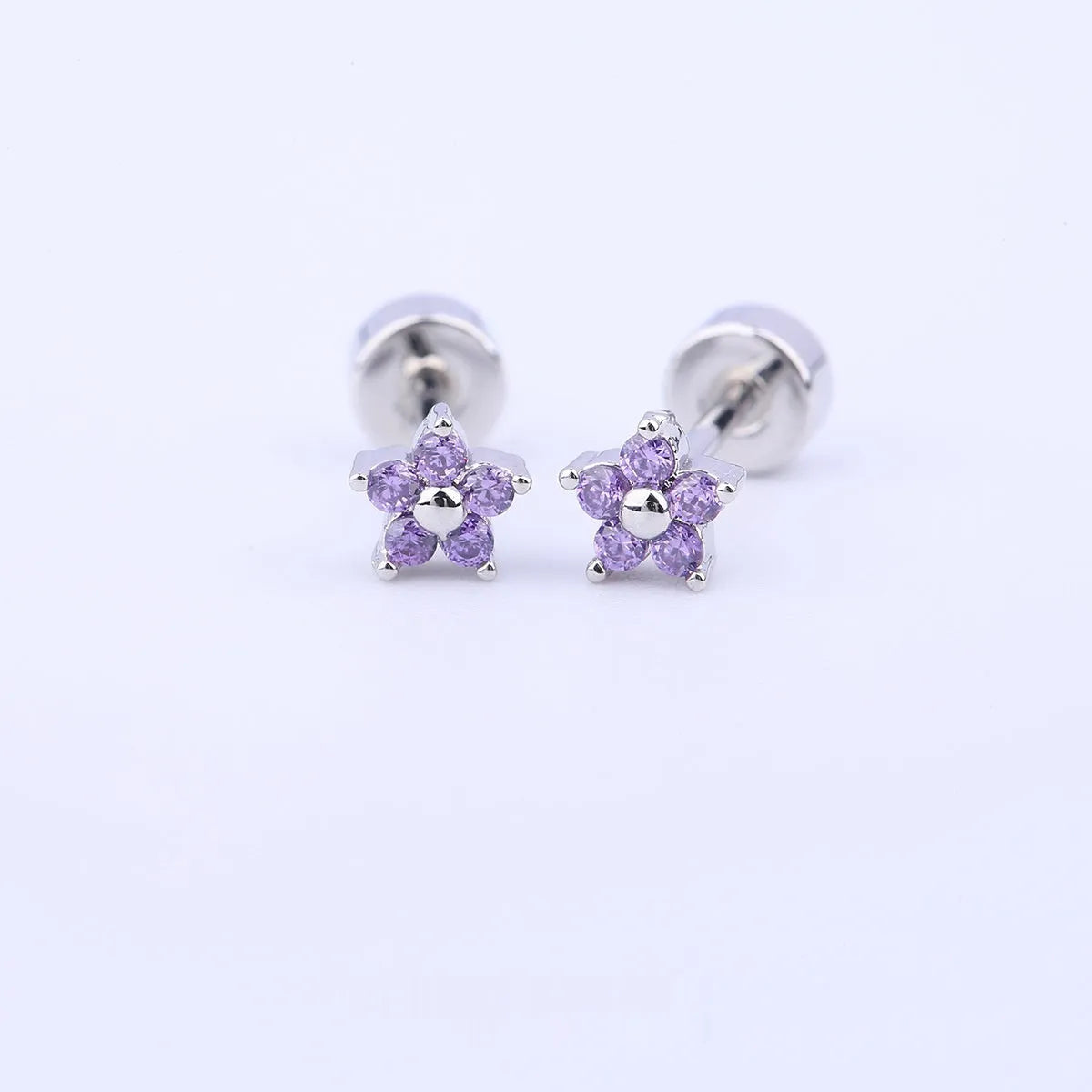 Copper-plated gold micro inlaid zircon five-petal plum flower ear studs on a white background, unisex design, real gold thick plating