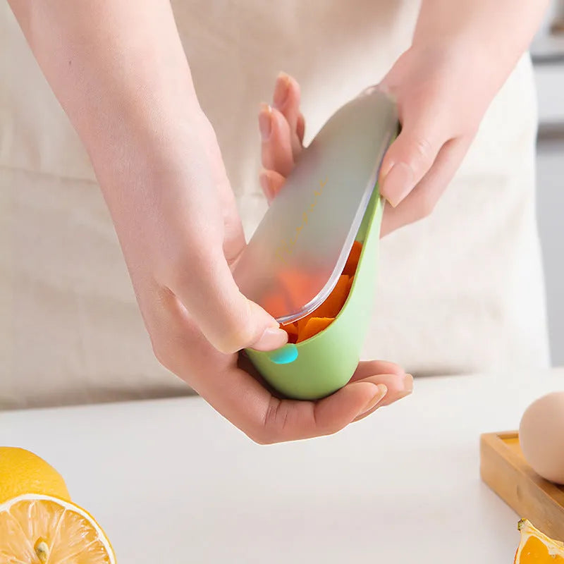 Dark green kitchen peeler with storage tube showing stainless steel blade and hanging hole