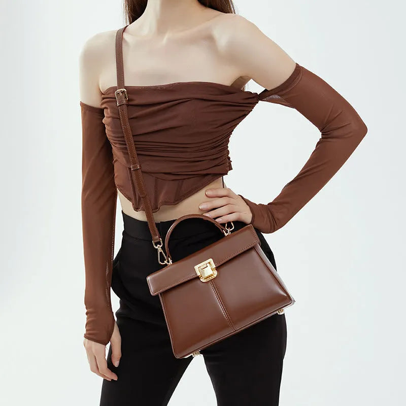 Black genuine leather women's shoulder bag with a front clasp, shown with a detailed view of the internal zip pocket.