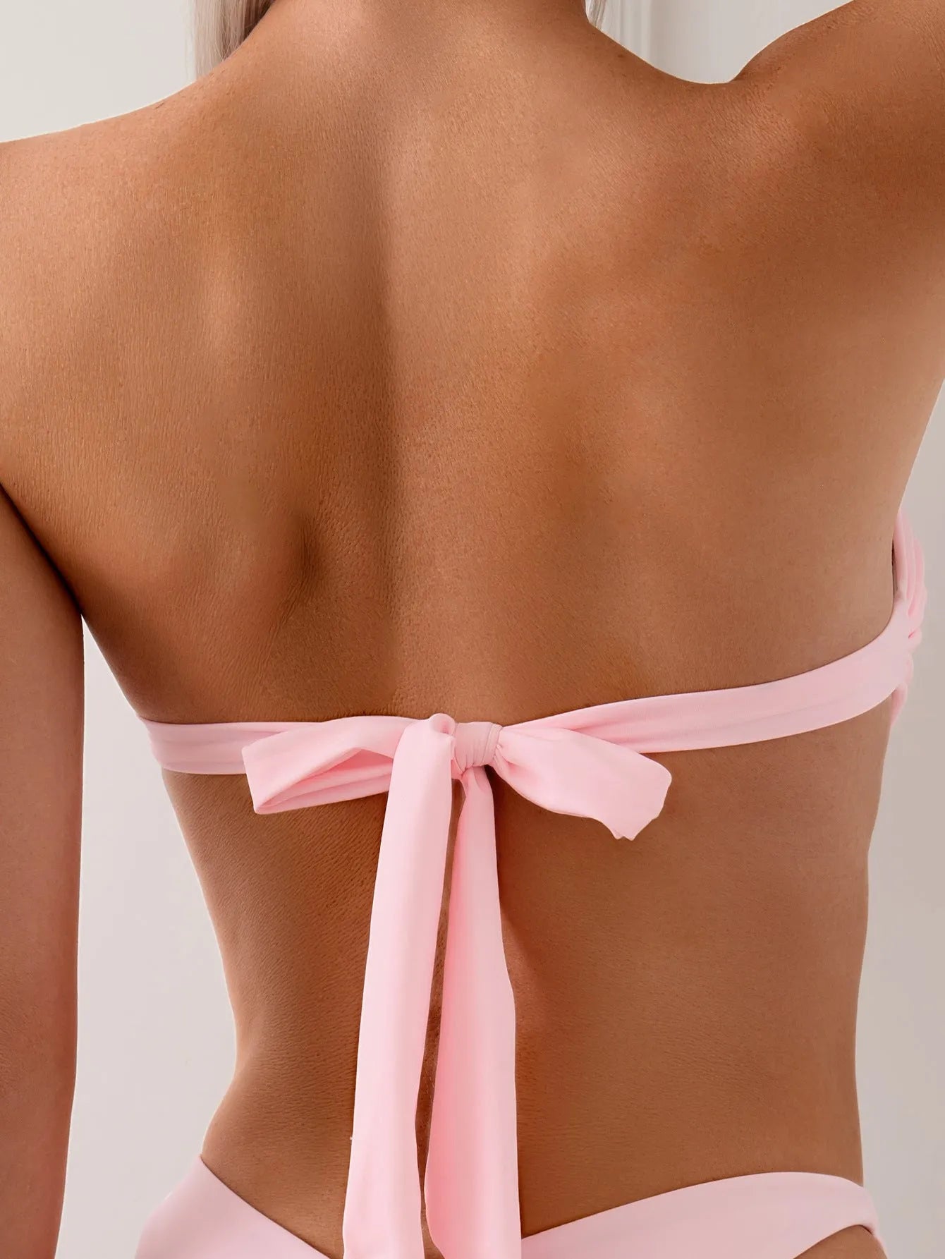 Women's pink bikini set with lace-up tube top and matching pants
