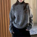 Women's loose cream pullover sweater with embroidered red love pattern on the front.