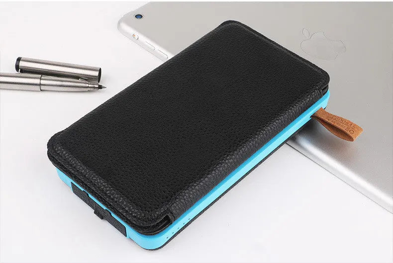 Black outdoor solar power bank with a solar panel, LED light, and soft leather finish, shown with a charging cable.