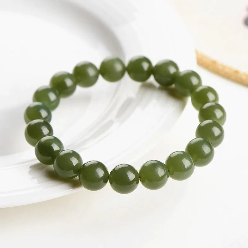Polished Hetian jade ball bracelet in a casual unisex style with spherical beads.