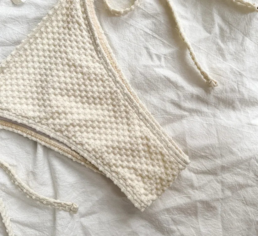 Women's halter neck lace-up bikini swimsuit in polyester fabric available in milky white, green, and white colours
