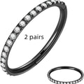 A stainless steel seamless nose ring in a round shape, shown alongside two pairs of matching stud earrings.