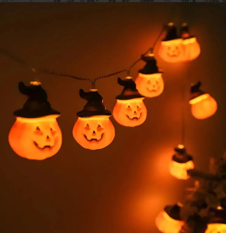 PVC Halloween lighting chain with pumpkin, ghost and bat shapes in warm white LED glow