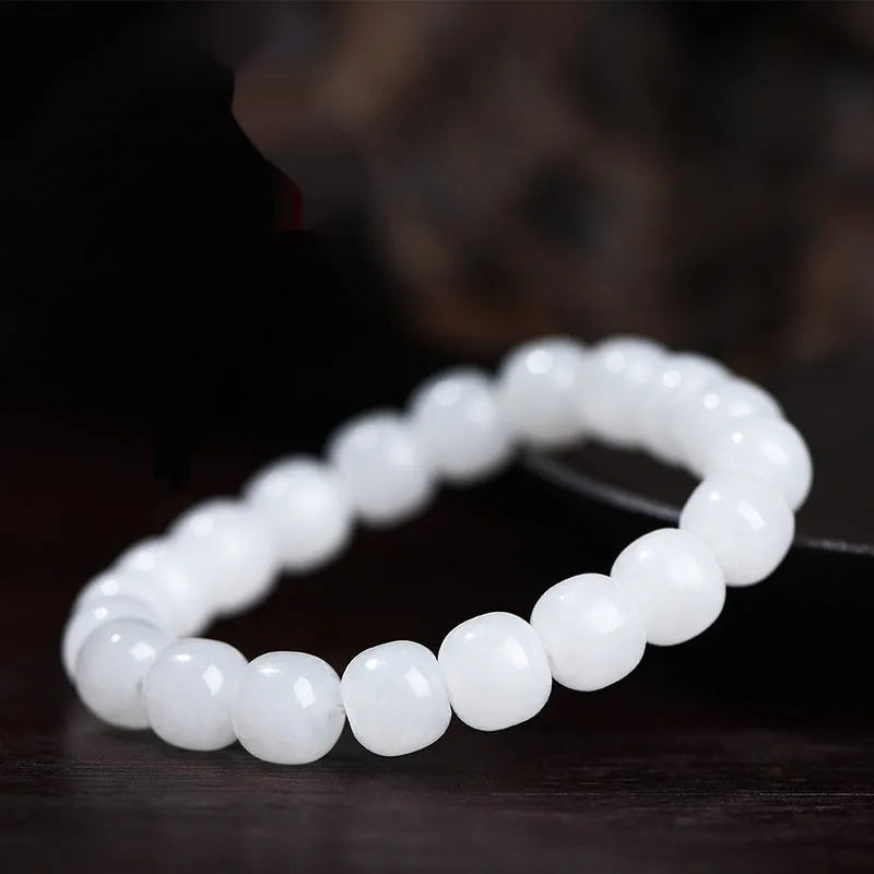 A white Hetian jade barrel bead bracelet showing three size options on a neutral background.